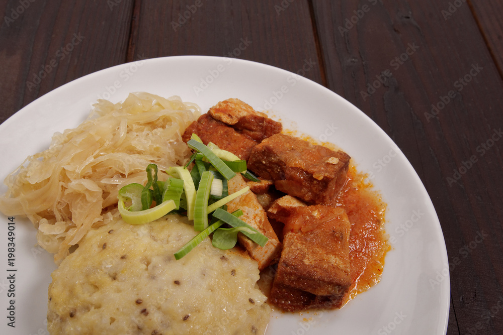 Tofu with cabbage and rice dumplings on a table Tofu with cabbage and rice dumplings on a table