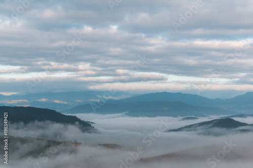 Beautiful landscape view of misty in morning over the mountain at sunrise time