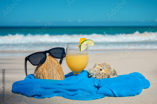 coconut, cocktail and glasses by the ocean photo