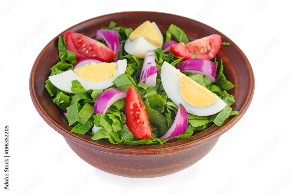 Clay bowl with salad (spinach, egg,onion, tomatoes)