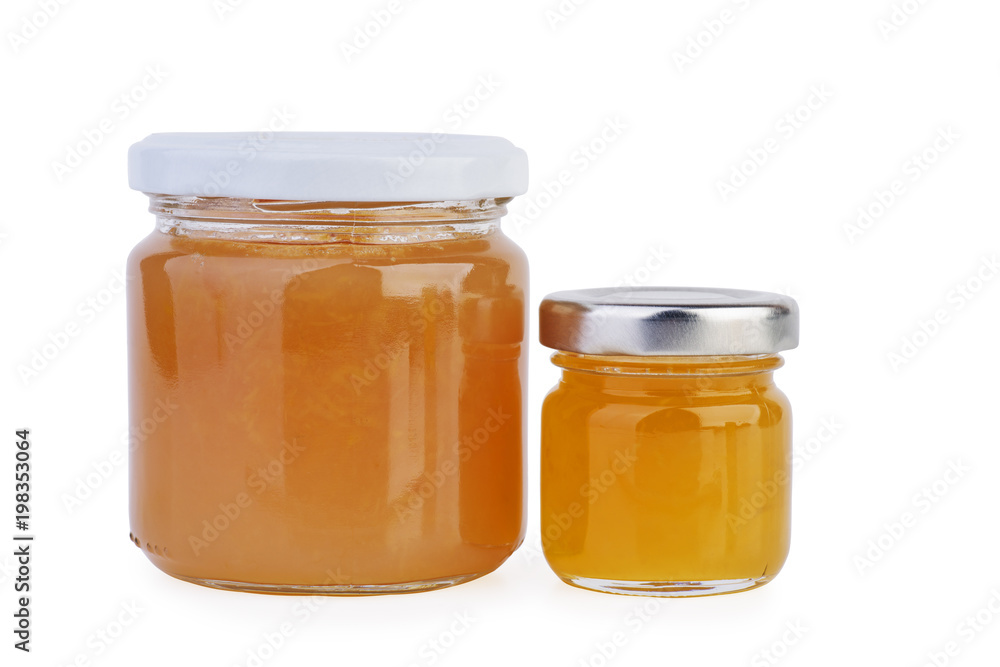 Two glass jars with orange jam or honey Two glass jars with orange jam or honey