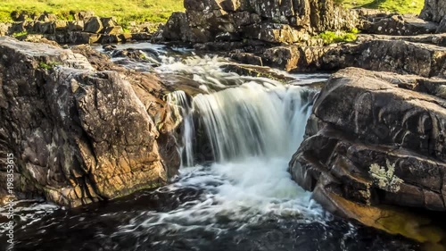 Dolly shot time lapse with long time exposure of the paradisal waterfall landscape in Glen Etive, Scotland - United Kingdom photo