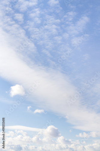 Blue spring sky with white fluffy clouds