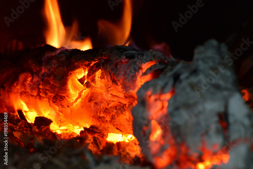 Fire in the fireplace, flames from burning coals on fire © andov