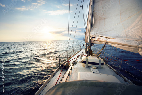 Canvas Print View from a deck of a tilted yacht in strong wind at sunset