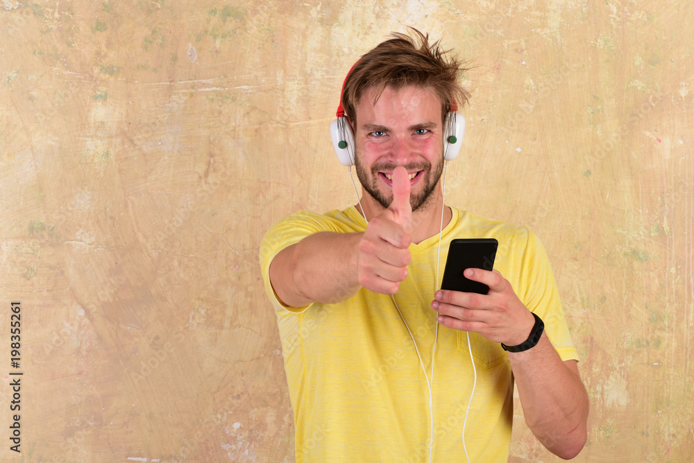Fototapeta premium Cheerful dj listening songs via earphones.
