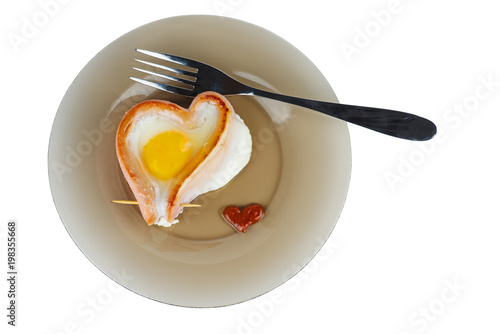 Fried egg and sausage on glass plate photo