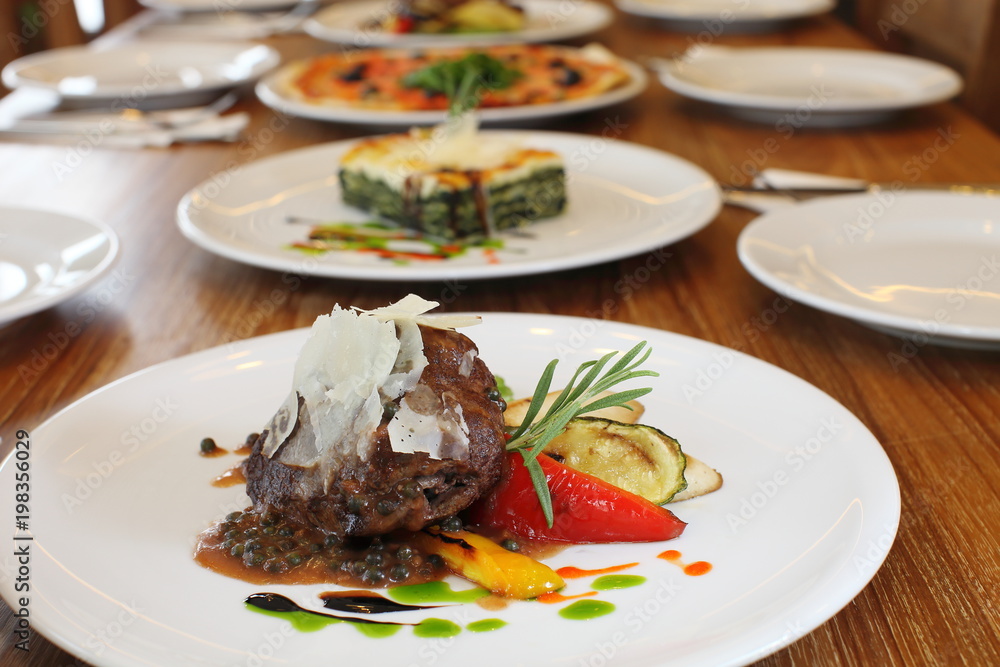 Filet mignon with black pepper sauce background with other italian food Filet mignon with black pepper sauce background with other italian food