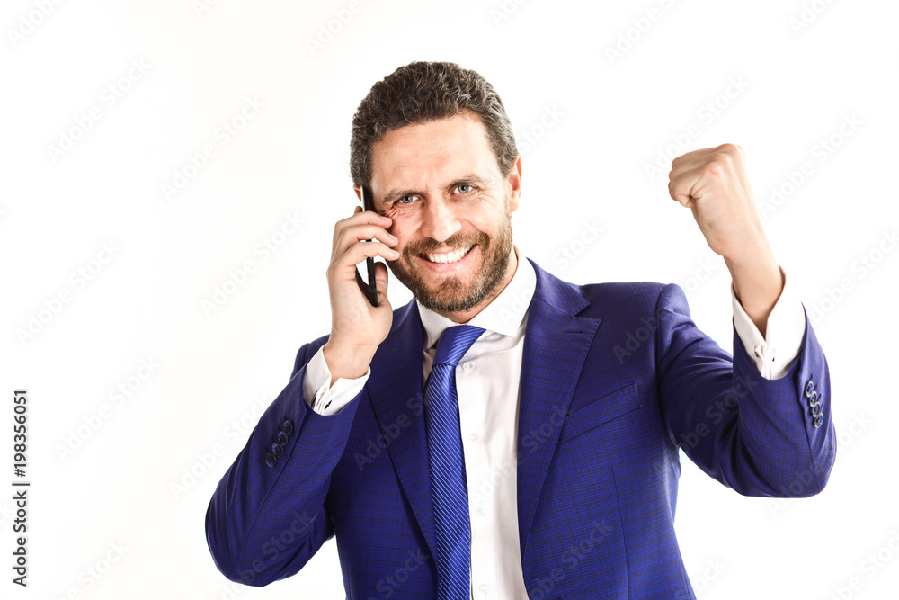 Businessman with happy face holds cell phone and raise fist. Businessman with happy face holds cell phone and raise fist.