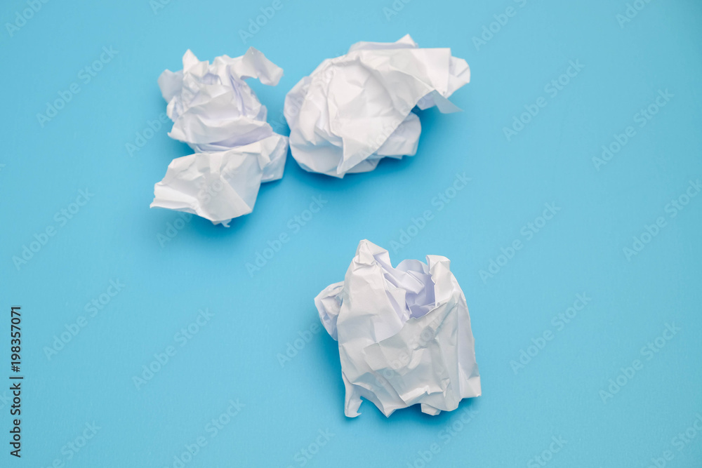 Crumpled paper balls on a blue background Crumpled paper balls on a blue background