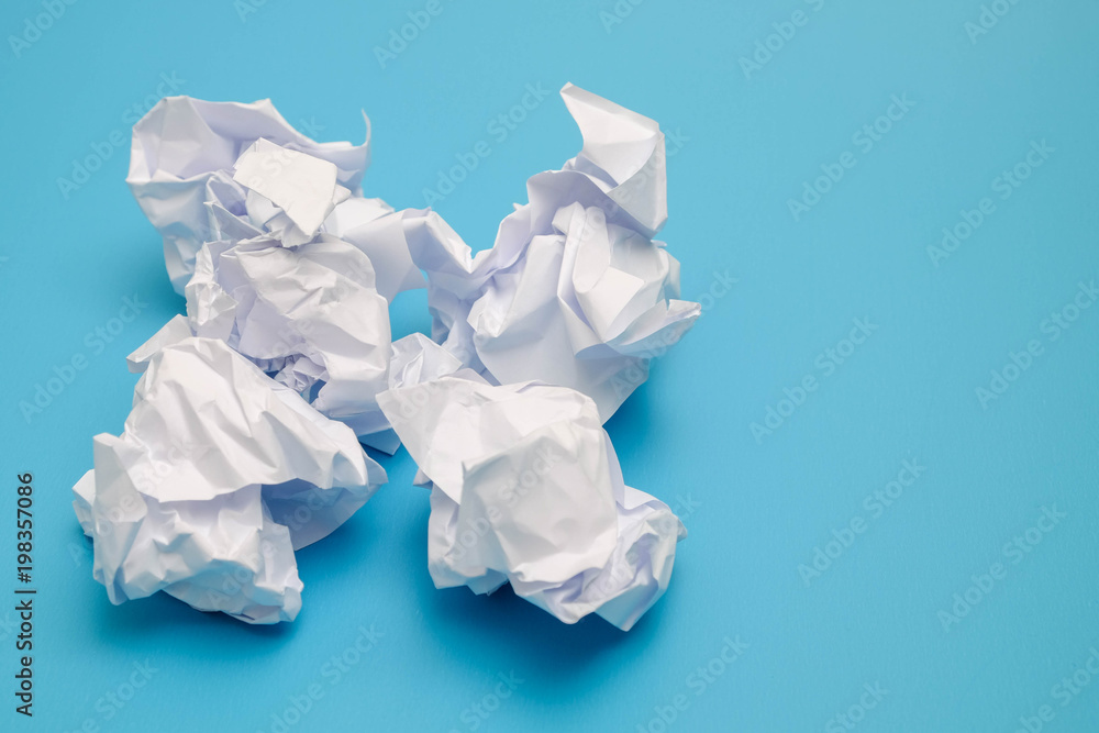 Crumpled paper balls on a blue background