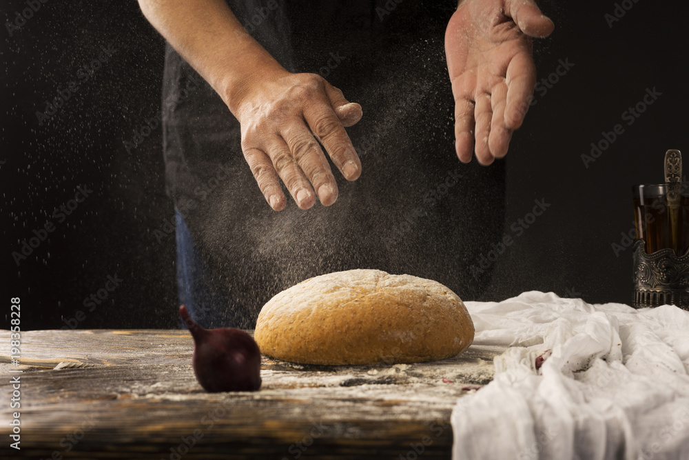 Conceptual art photography of a old woman hands drops hands, pour flour on bread