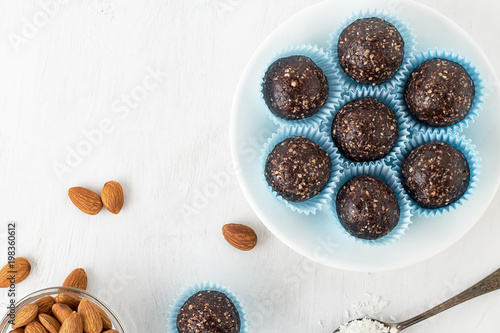 Chocolate energy bites with nuts, cocoa powder, dates and coconut flakes.