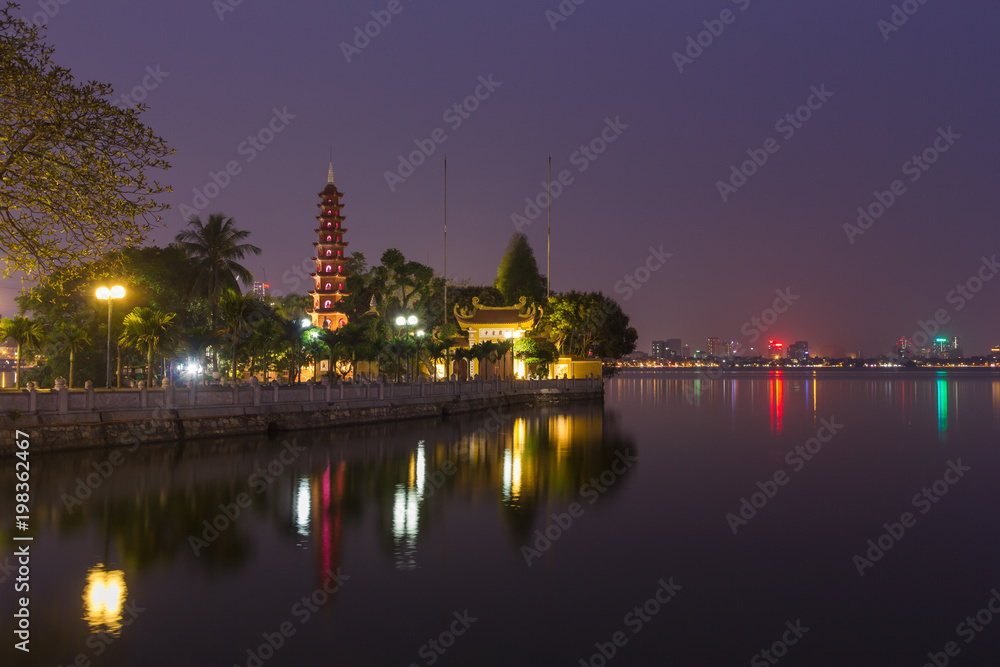 Beautiful night view of the Tran Quoc Pagoda on the small peninsula (The most ancient pagoda in Hanoi, originally constructed in the 6th century), East side of West Lake, Hanoi, Vietnam