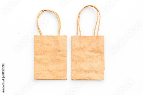 Brown kraft paper bag for shopping on white background top view mockup