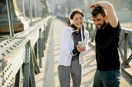 Athletic couple is having a rest after jogging in the city