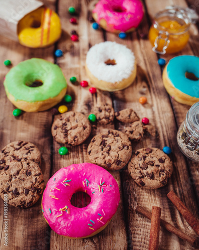 Colorful donuts on wooden table. Top view	