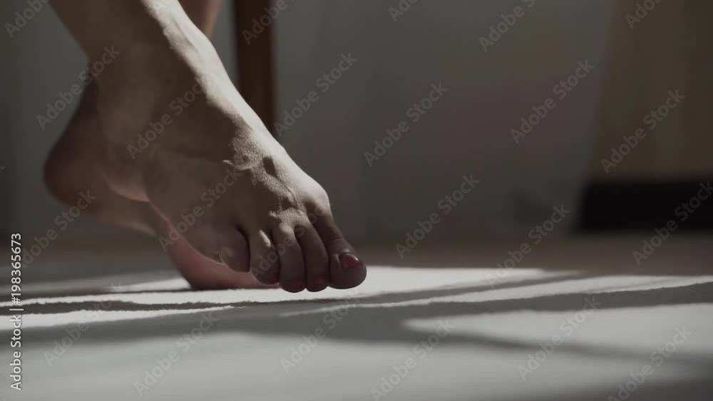 The legs of a woman are walking on the floor The legs of a woman are walking on the floor