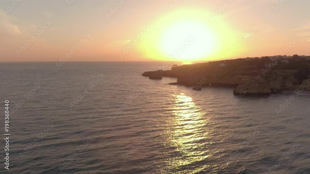 Aerial view of the ocean shore at sunset
