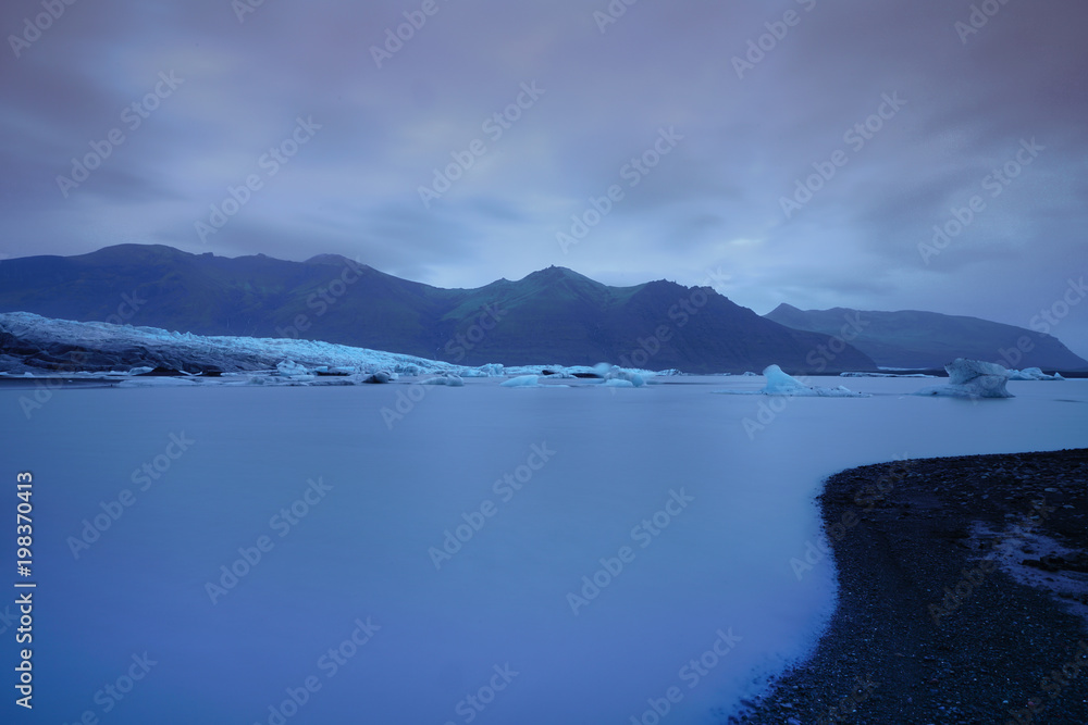 A Vatnajokul Gracier panorama an long exposure photography in the volcanic ashes and black sand on the front, Iceland A Vatnajokul Gracier panorama an long exposure photography in the volcanic ashes and black sand on the front, Iceland