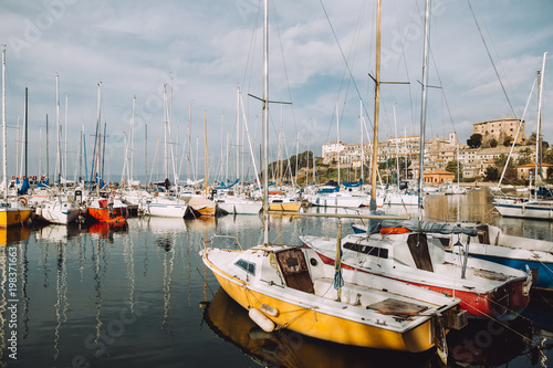 Mirror image of the boats in a marina in italy
