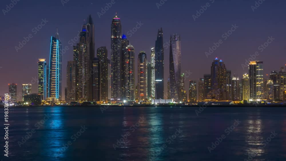 Dusk to night transition of Dubai Marina cityscape, View from Palm Jumeirah, time lapse, United Arab Emirates. Dusk to night transition of Dubai Marina cityscape, View from Palm Jumeirah, time lapse, United Arab Emirates.