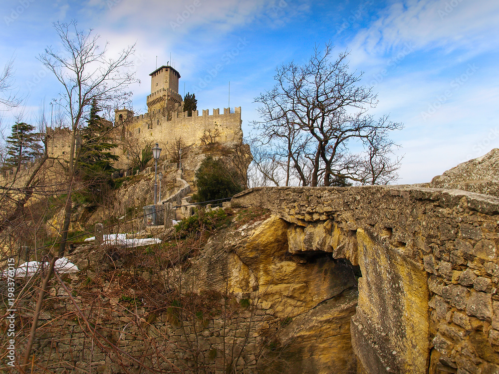 The Fortress Guaita viewed from The Pass of the Witches with stone bridge in San Marino