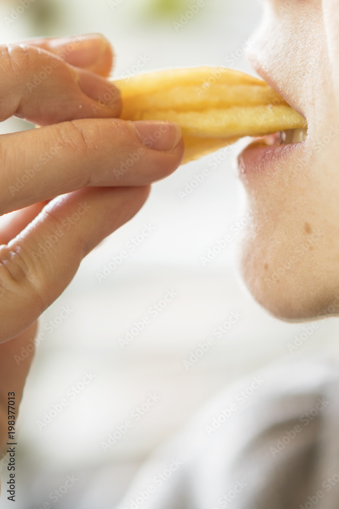 woman eating french fries. The concept of harmful food that causes cancer.