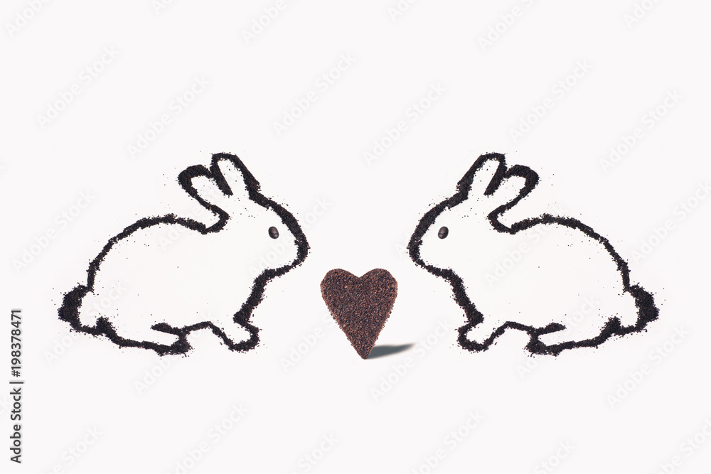 Two Easter bunny from coffee ground with huge heart cookie on a white background Two Easter bunny from coffee ground with huge heart cookie on a white background