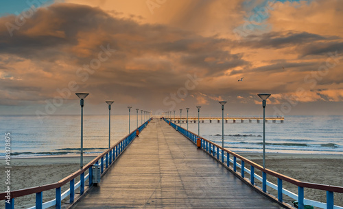 Colorful sunset at a famous marine pier in the Baltic resort city of Palanga,...