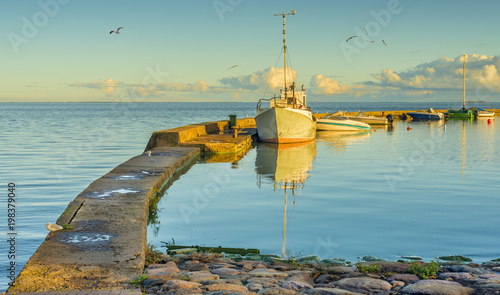 Motorboats docked near a stone pier at harbor of Nida village, Curonian spit,...