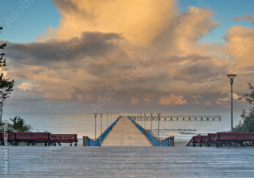Colorful sunset at a famous marine pier in the Baltic resort city of Palanga,...