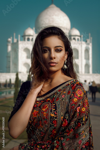 beautiful dark hair girl at taj mahal in agra in india
