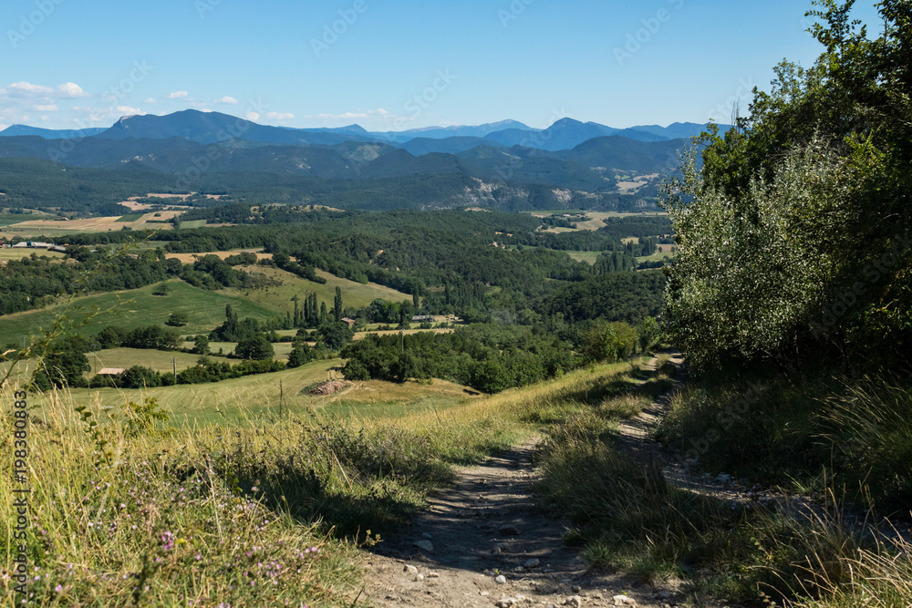 Green alpine valley with Vercors mountains on a background. France 2017.