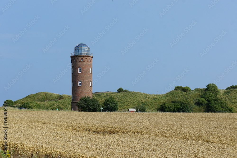 Lighthouse in fields on a coast Lighthouse in fields on a coast