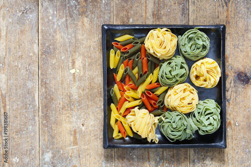 Ingredients for Italian pasta meal with tagliatelle, garlic and penne pasta photo