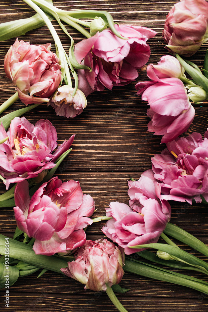 Beautiful spring composition with tender pink flowers on wooden background