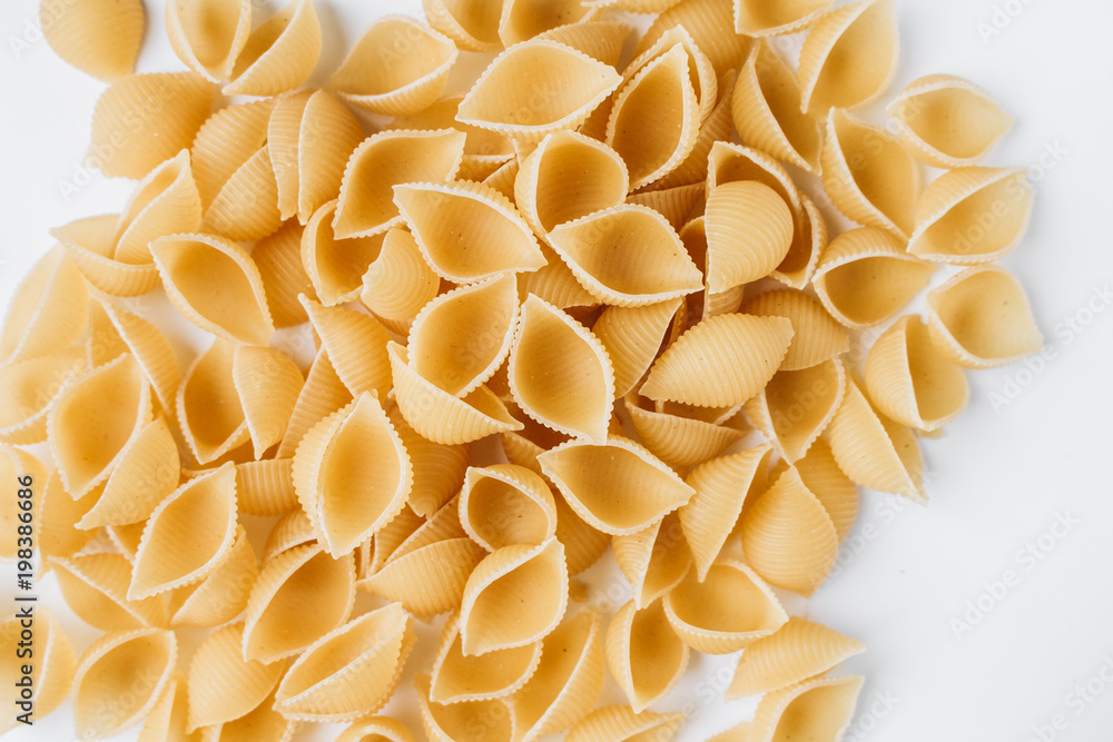 Pile of uncooked macaroni, food background Pile of uncooked macaroni, food background