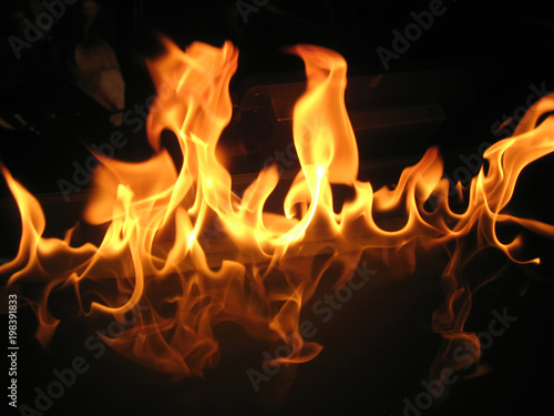 Background of fire. Flame tongues on a dark background.