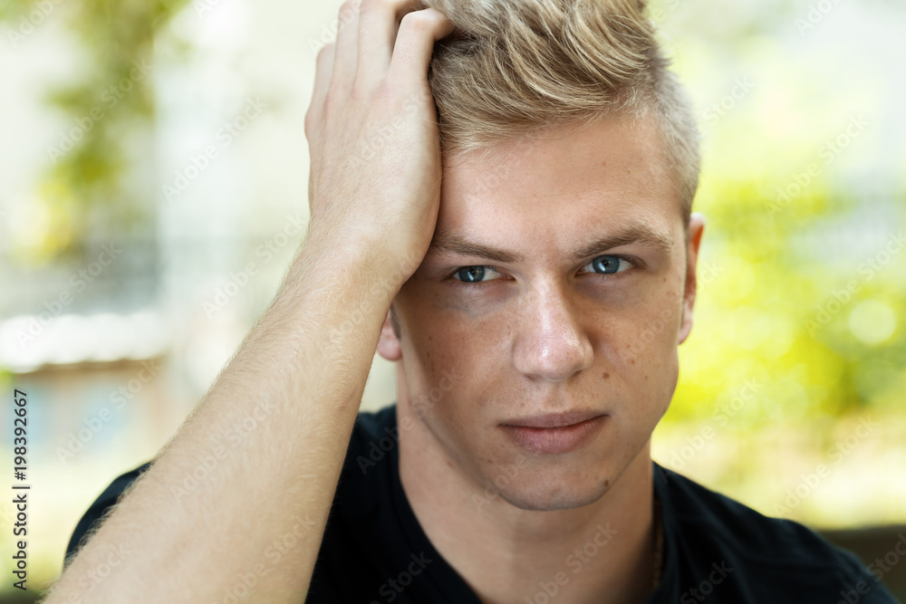 Portrait of a pretty man stress and headache having migraine pain Portrait of a pretty man stress and headache having migraine pain