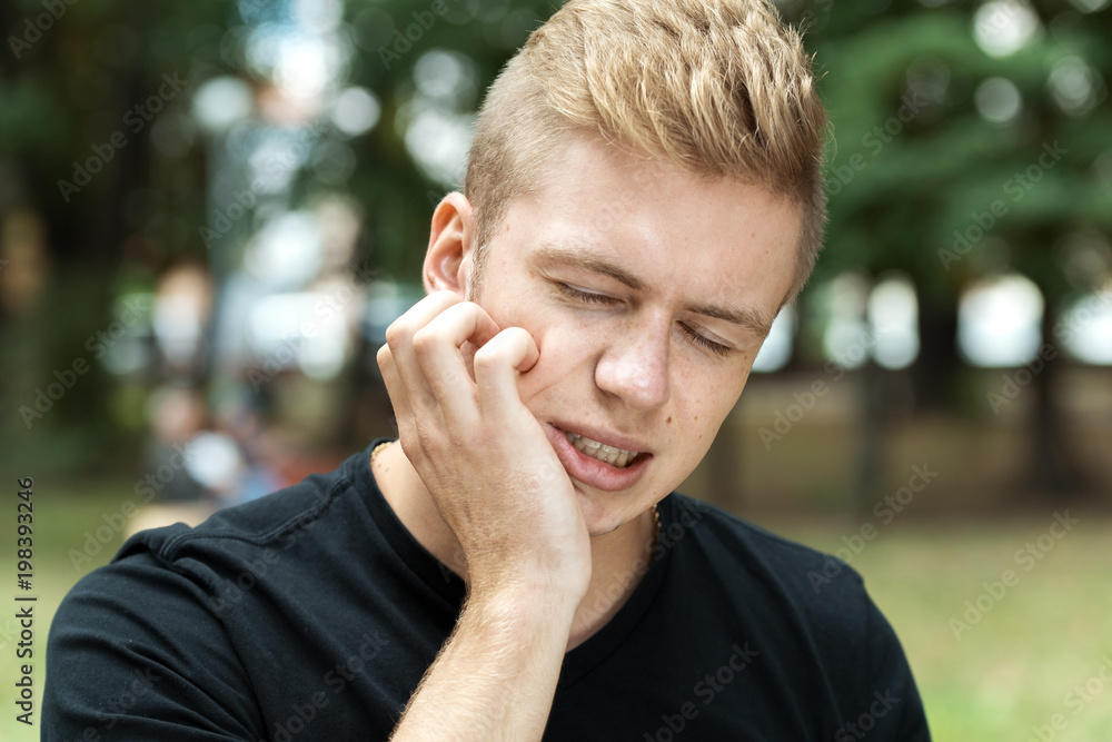 Outdore portrait of a man having toothache Outdore portrait of a man having toothache