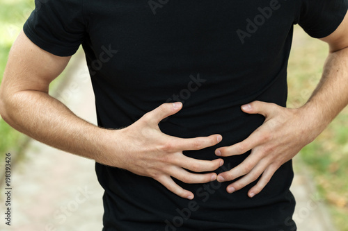 Outdoor portrait of a pretty woman  with stomach issues