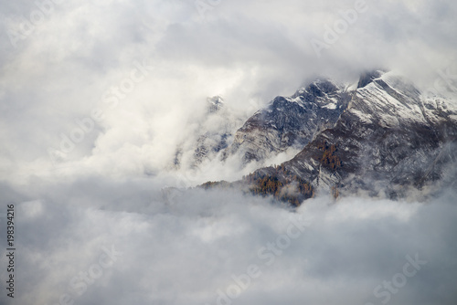 Aerial image of beautiful mountain landscape with clouds in the Valais Kanton