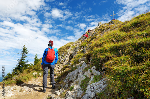 Tourists on hiking trails of picturesque Tegelberg mountain, a part of Ammergau Alps, located nead Fussen town, Germany. photo