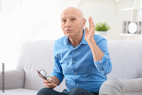 Senior man with hearing aid...