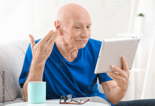 Senior man with hearing aid...