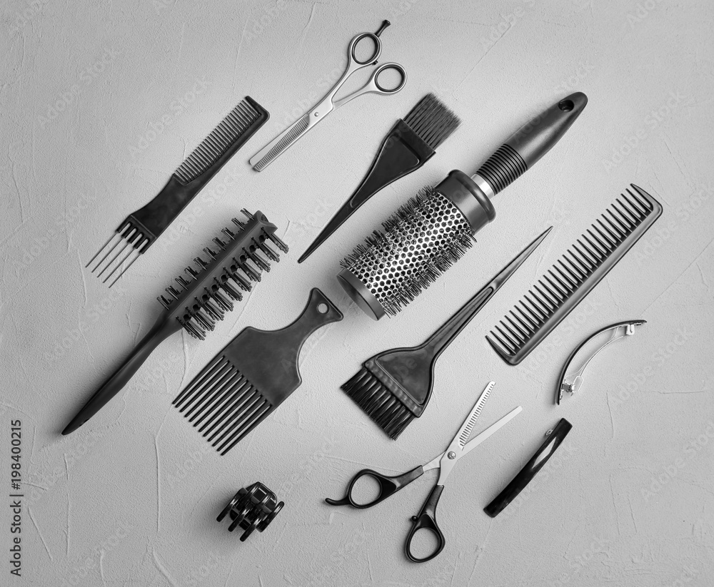 Fototapeta premium Flat lay composition with professional hairdresser tools on grey background