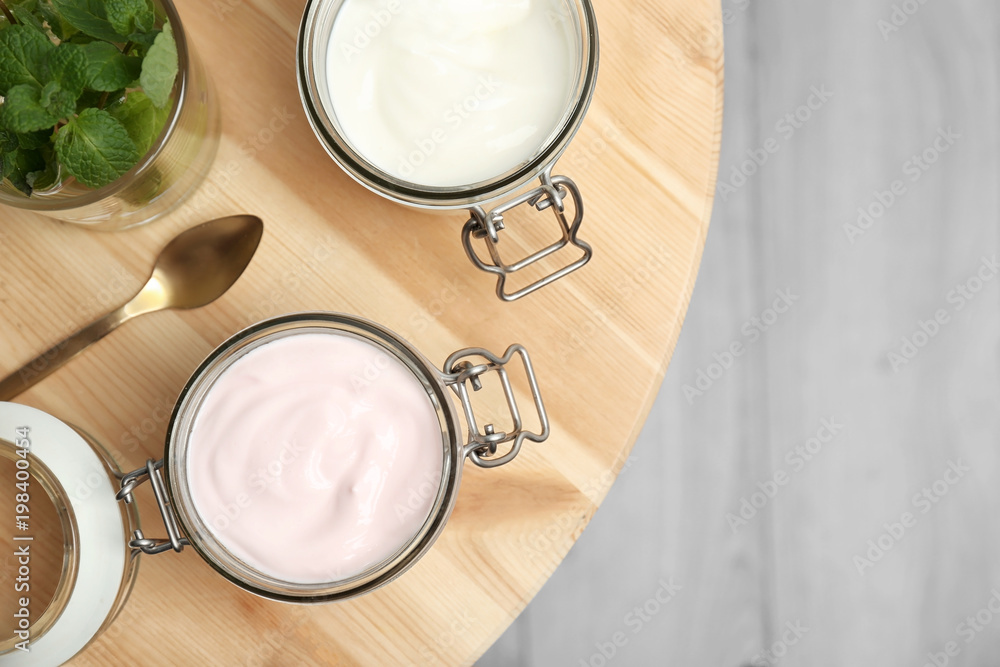 Jars with different yogurts on table Jars with different yogurts on table