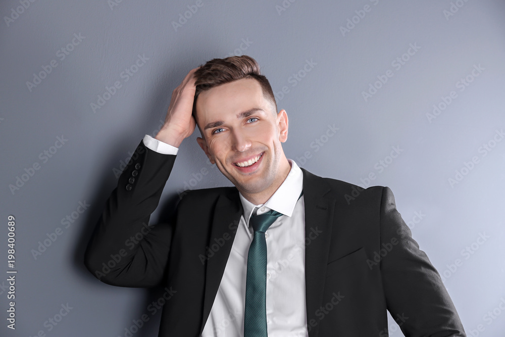 Portrait of young man with beautiful hair on grey background Portrait of young man with beautiful hair on grey background