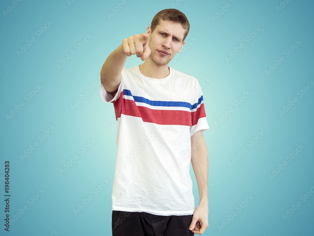 portrait of young smiling man points finger isolated portrait of young smiling man points finger isolated